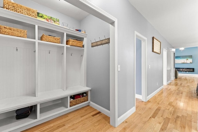 mudroom featuring light wood-style flooring and baseboards
