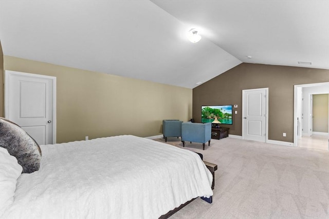 bedroom featuring lofted ceiling, light carpet, and baseboards
