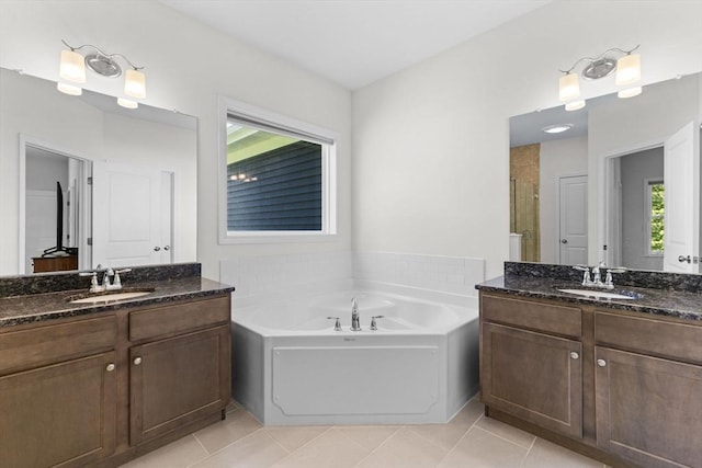 bathroom featuring a stall shower, tile patterned floors, and two vanities