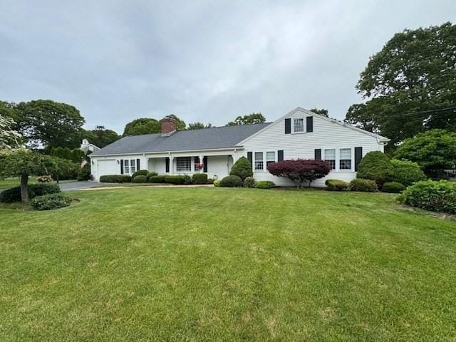 18 Lily Pond Dr, Yarmouth, MA 02664 - view of front of home with a garage, a front yard, and driveway