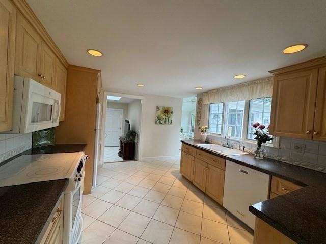 18 Lily Pond Dr, Yarmouth, MA 02664 - kitchen featuring white appliances, dark countertops, decorative backsplash, light tile patterned flooring, and recessed lighting
