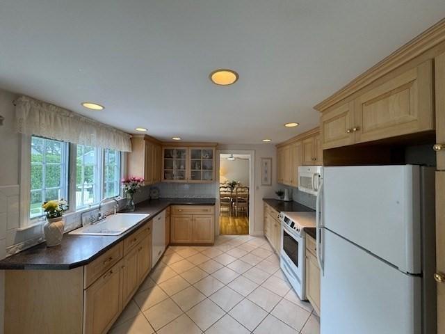 18 Lily Pond Dr, Yarmouth, MA 02664 - kitchen featuring white appliances, dark countertops, recessed lighting, decorative backsplash, and light tile patterned floors