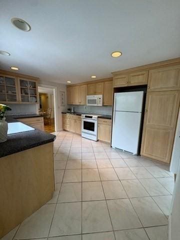 18 Lily Pond Dr, Yarmouth, MA 02664 - kitchen featuring white appliances, dark countertops, light tile patterned floors, recessed lighting, and light brown cabinetry