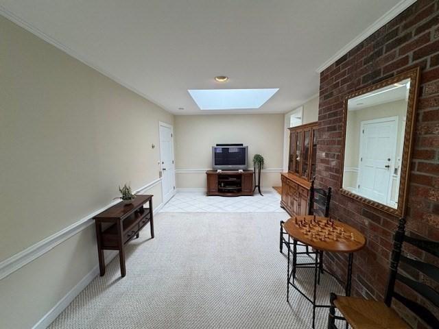18 Lily Pond Dr, Yarmouth, MA 02664 - living area with a skylight, light carpet, crown molding, and brick wall