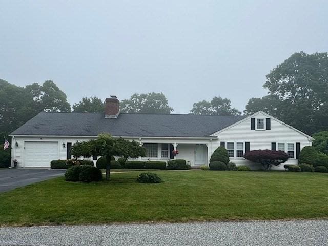 18 Lily Pond Dr, Yarmouth, MA 02664 - single story home with driveway, an attached garage, a front yard, and a chimney