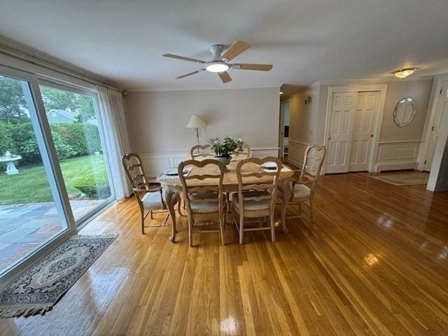 18 Lily Pond Dr, Yarmouth, MA 02664 - dining space with light wood-type flooring, ceiling fan, a decorative wall, wainscoting, and crown molding
