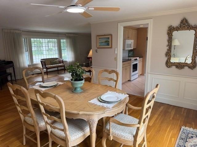 18 Lily Pond Dr, Yarmouth, MA 02664 - dining area with ornamental molding, ceiling fan, light wood-style flooring, and a decorative wall