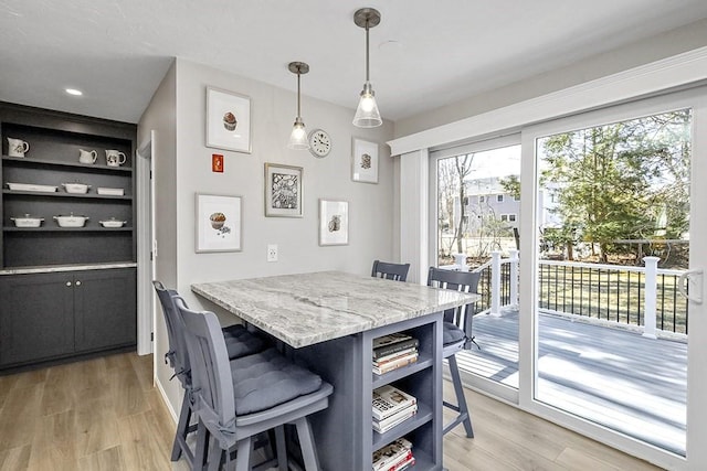 dining area with built in features and light wood-type flooring