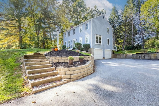 view of side of property with a garage and driveway