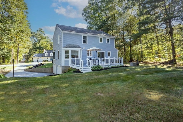 back of property with a lawn and a wooden deck