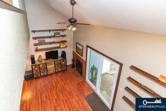 199 Lake St Unit 26, Weymouth, MA 02189 - living room featuring a ceiling fan, lofted ceiling, wood finished floors, and a brick fireplace