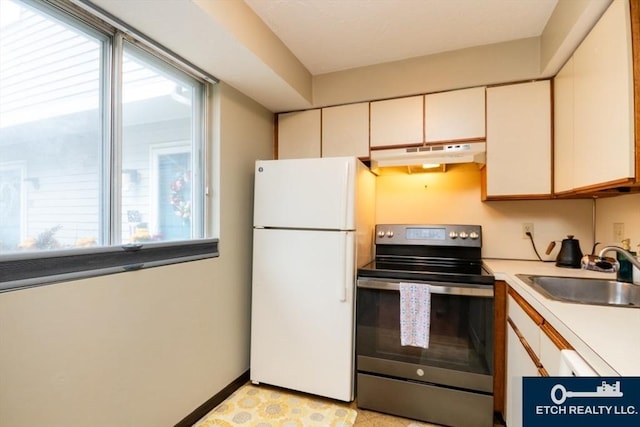 199 Lake St Unit 26, Weymouth, MA 02189 - kitchen with freestanding refrigerator, stainless steel range with electric cooktop, under cabinet range hood, and plenty of natural light