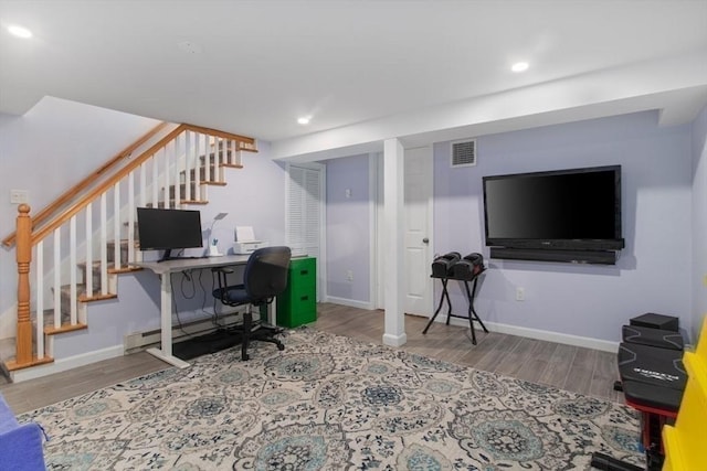 office area with a baseboard radiator, recessed lighting, wood finished floors, visible vents, and baseboards