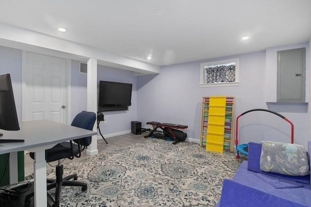 office area featuring recessed lighting, wood finished floors, visible vents, baseboards, and electric panel