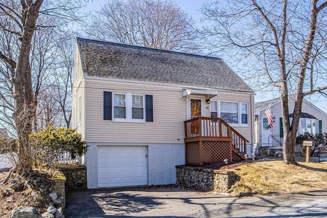 view of front of home featuring aphalt driveway, roof with shingles, and an attached garage