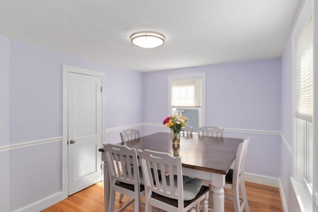 dining room with baseboards and light wood-style floors