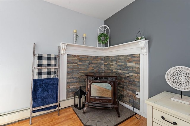 224 Church, Pembroke, NH 03275 - detailed view of wood finished floors, a baseboard heating unit, and a wood stove