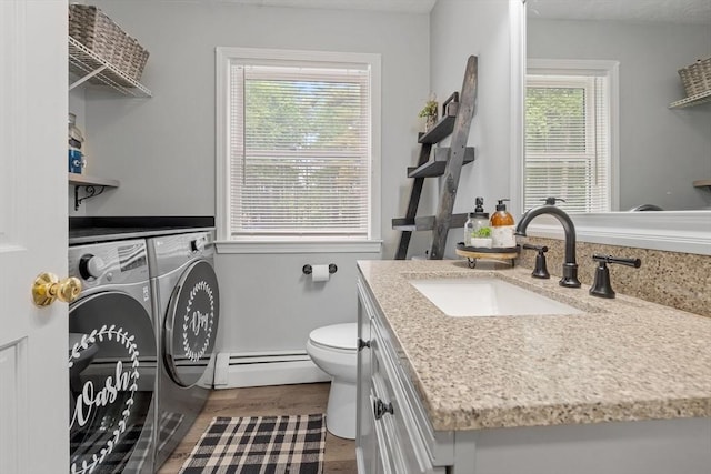 224 Church, Pembroke, NH 03275 - laundry area featuring baseboard heating, independent washer and dryer, and wood finished floors