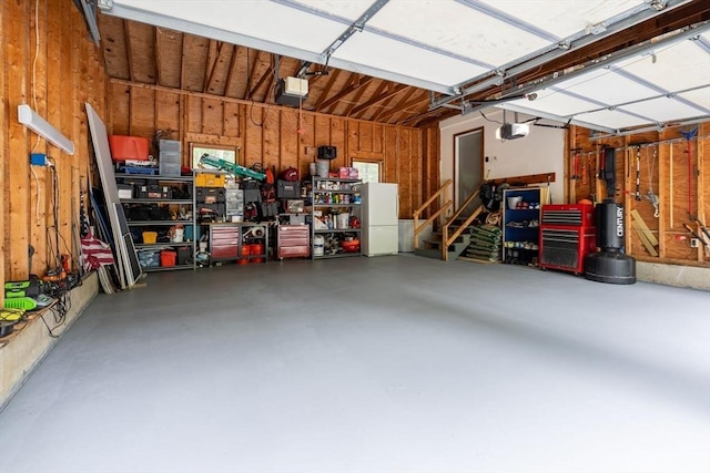 224 Church, Pembroke, NH 03275 - garage with wooden walls and a garage door opener