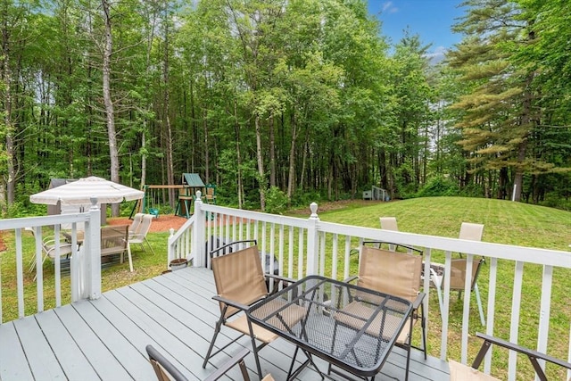 224 Church, Pembroke, NH 03275 - deck featuring outdoor dining area, a playground, and a yard