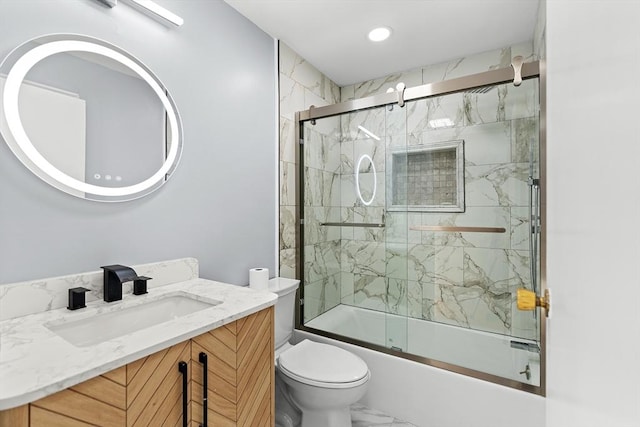 full bathroom with vanity, toilet, and bath / shower combo with glass door