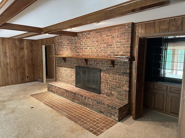96 Wild Grove Ln, Longmeadow, MA 01106 - unfurnished living room featuring light colored carpet, wood walls, beamed ceiling, and a fireplace