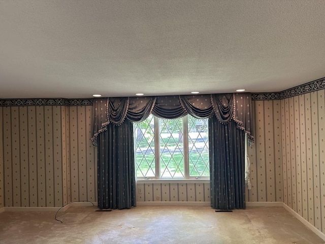 96 Wild Grove Ln, Longmeadow, MA 01106 - unfurnished dining area featuring a textured ceiling, carpet floors, wallpapered walls, and baseboards