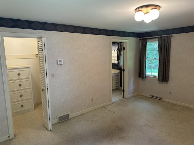 96 Wild Grove Ln, Longmeadow, MA 01106 - unfurnished bedroom featuring light carpet, baseboards, ensuite bath, and a closet