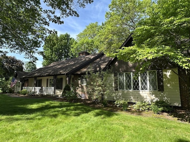 96 Wild Grove Ln, Longmeadow, MA 01106 - view of front of home with a front lawn, covered porch, and a chimney