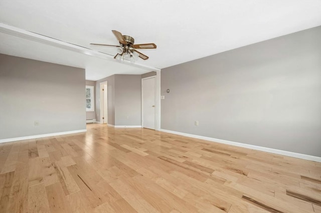 unfurnished room featuring ceiling fan, light hardwood / wood-style flooring, and a baseboard heating unit