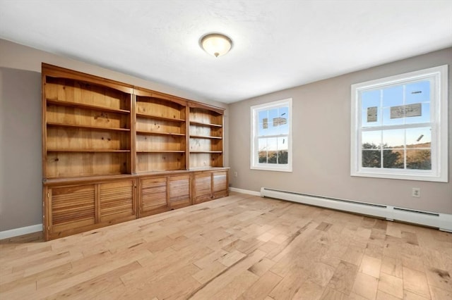 interior space featuring baseboard heating and light wood-type flooring