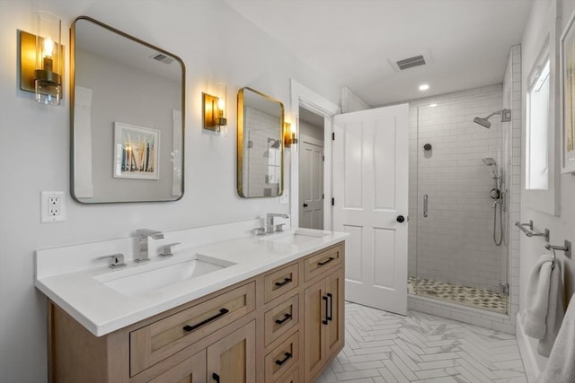 bathroom with vanity and a shower with shower door