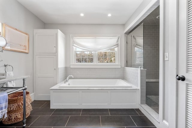 bathroom with separate shower and tub and tile patterned floors