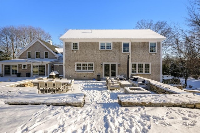 view of snow covered rear of property