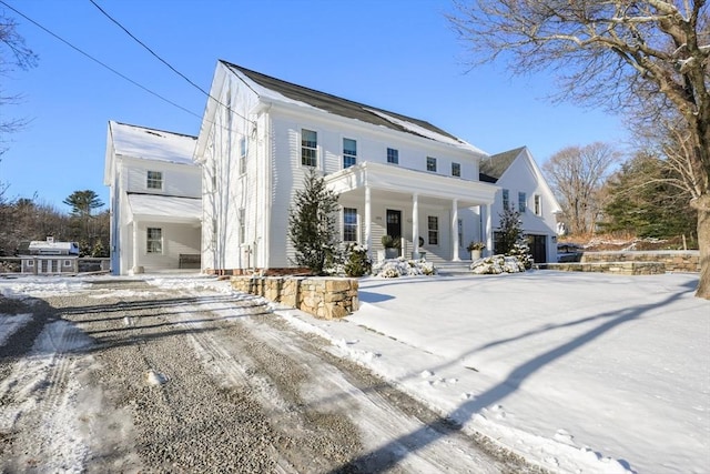 view of front facade with a garage and covered porch