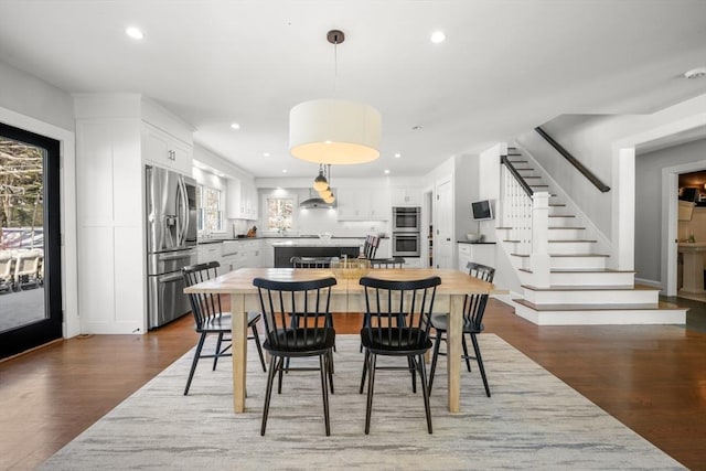 dining space with plenty of natural light and dark hardwood / wood-style floors