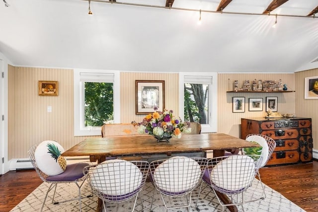 dining space featuring dark wood-type flooring, wood walls, vaulted ceiling, and a baseboard heating unit