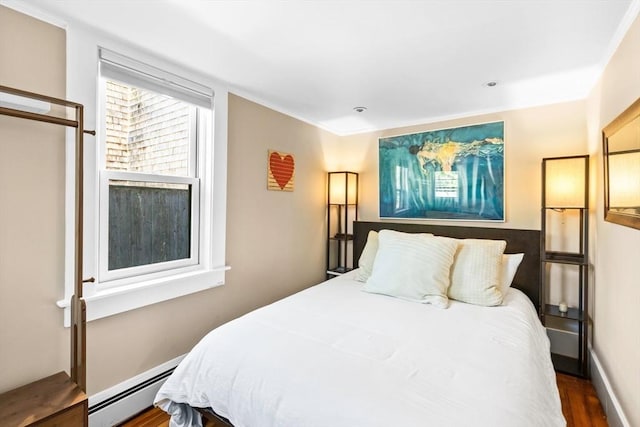 bedroom featuring a baseboard radiator and dark hardwood / wood-style floors