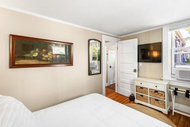 bedroom with crown molding and hardwood / wood-style flooring