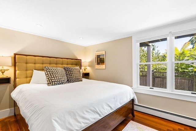 bedroom with dark hardwood / wood-style flooring, crown molding, and a baseboard radiator