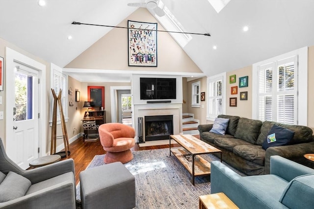 living room with wood-type flooring, a wealth of natural light, and high vaulted ceiling