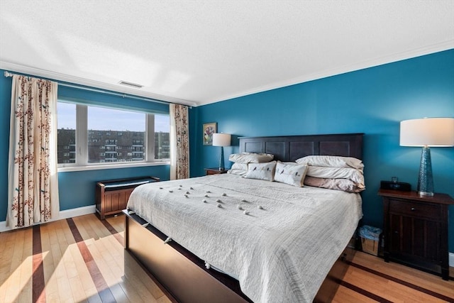 150 Lynnway Unit 406, Lynn, MA 01902 - bedroom with hardwood / wood-style flooring, ornamental molding, and a textured ceiling