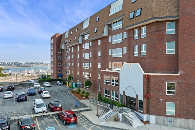 150 Lynnway Unit 406, Lynn, MA 01902 - view of building exterior featuring uncovered parking and a water view