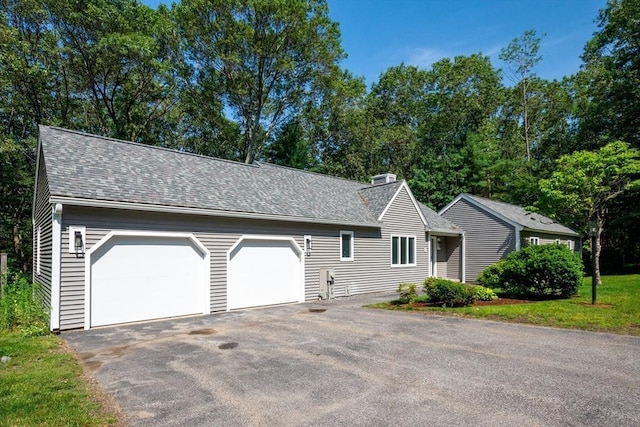 17 Indian Dawn Unit 17, Wayland, MA 01778 - view of front of home featuring a chimney, a shingled roof, asphalt driveway, and an attached garage