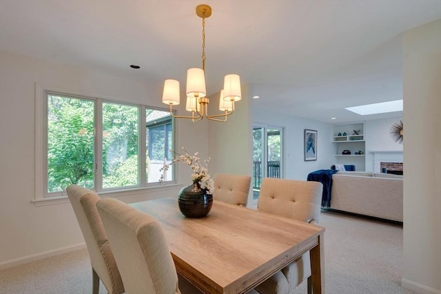 17 Indian Dawn Unit 17, Wayland, MA 01778 - dining room with carpet, a skylight, a chandelier, a brick fireplace, and recessed lighting
