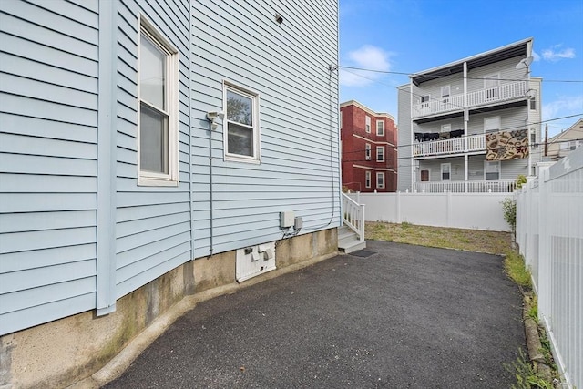 view of side of home featuring a fenced backyard and a patio area
