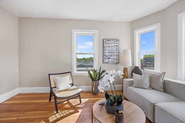 sitting room with hardwood / wood-style flooring and baseboards