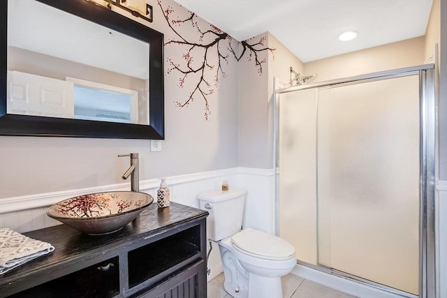 bathroom with toilet, tile patterned flooring, walk in shower, and vanity