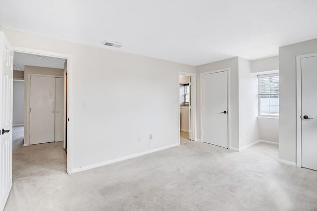 unfurnished bedroom with light colored carpet