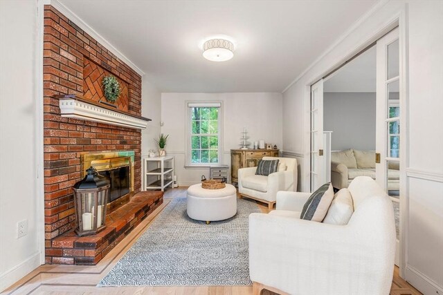 4 Rockwood Ln, Londonderry, NH 03053 - living room featuring a brick fireplace and baseboards